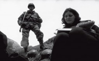 Two trades; a soldier looks on as di Giovanni reports from Bosnia