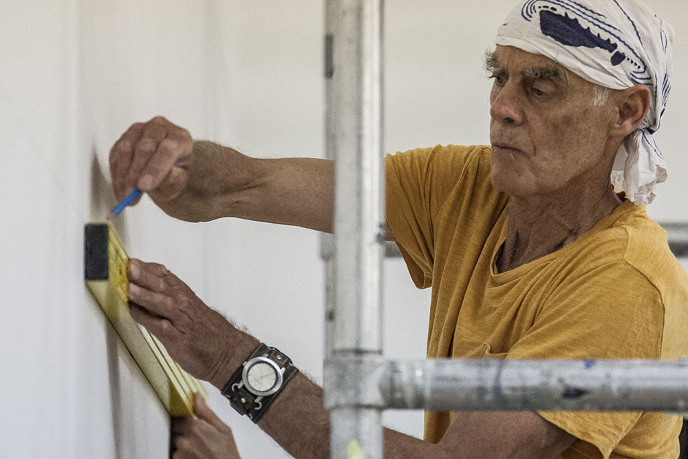 Richard Long installing Muddy Water Falls, 2015. Photograph by Stephen Jackson