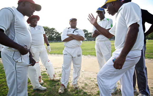 The Progressive Cricket Club discusses strategy one Sunday during a game at Marine Park in Brooklyn.