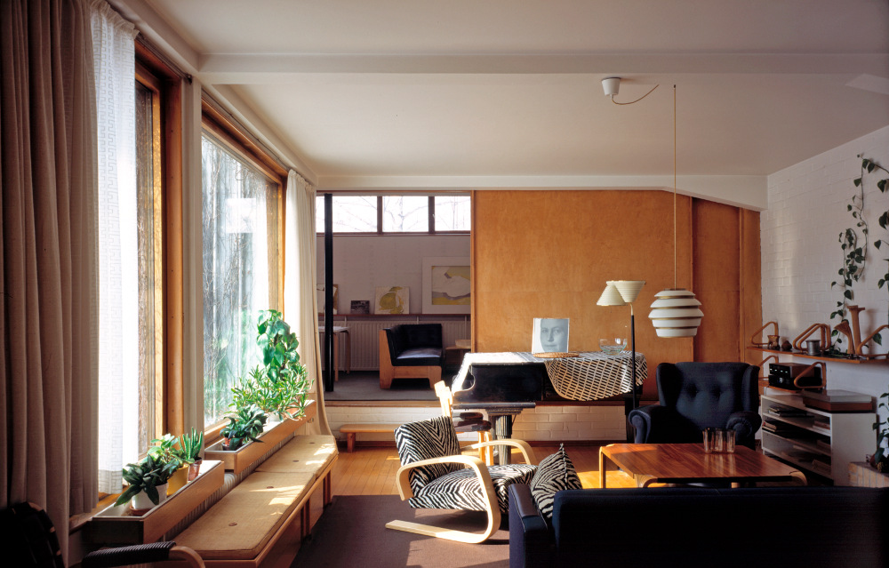The Aalto House living room with a sliding door to the studio behind