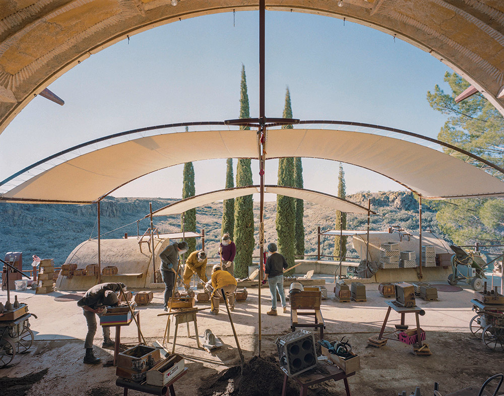 Craftspeople at work in the foundry making the famous bronze Soleri wind bells. Like the ceramics studio, the foundry is sheltered in an apse, open to the south