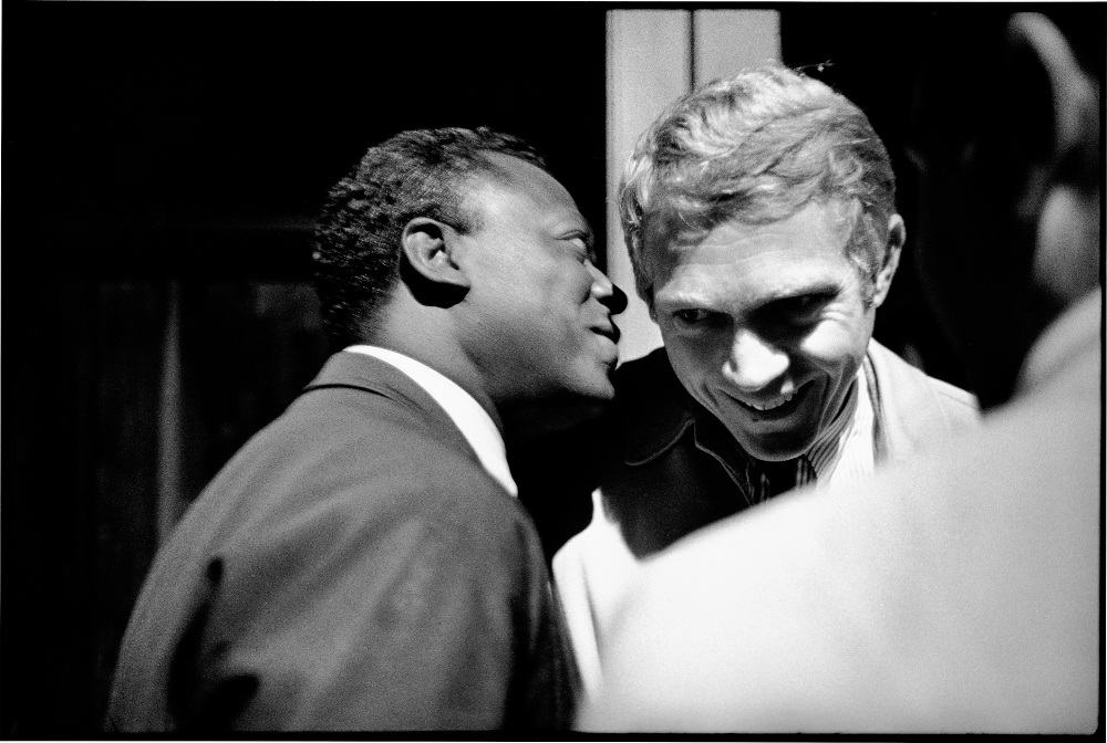 Miles Davis in conversation with actor Steve McQueen, backstage at the 1963 Monterey jazz festival. Photograph: © Jim Marshall Photography LLC / Reel Art Press