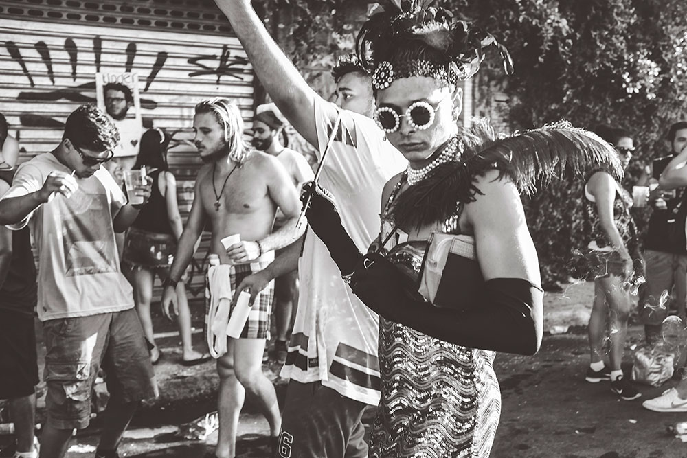 A man passes by in flamboyant carnival dress